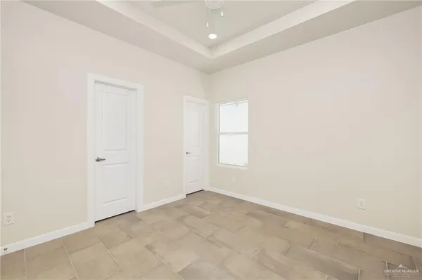 an empty room with windows and closet