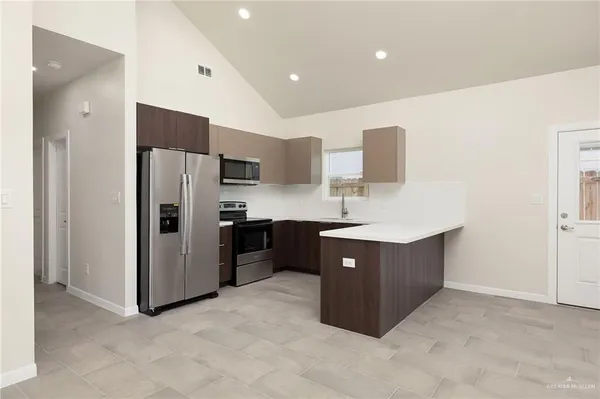 a kitchen with stainless steel appliances a refrigerator and a sink