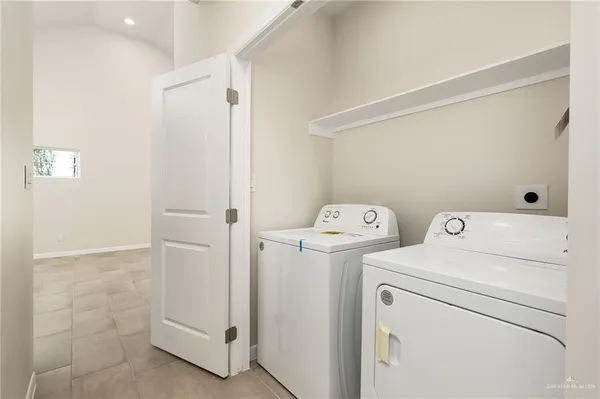 a view of bathroom with a washer and dryer