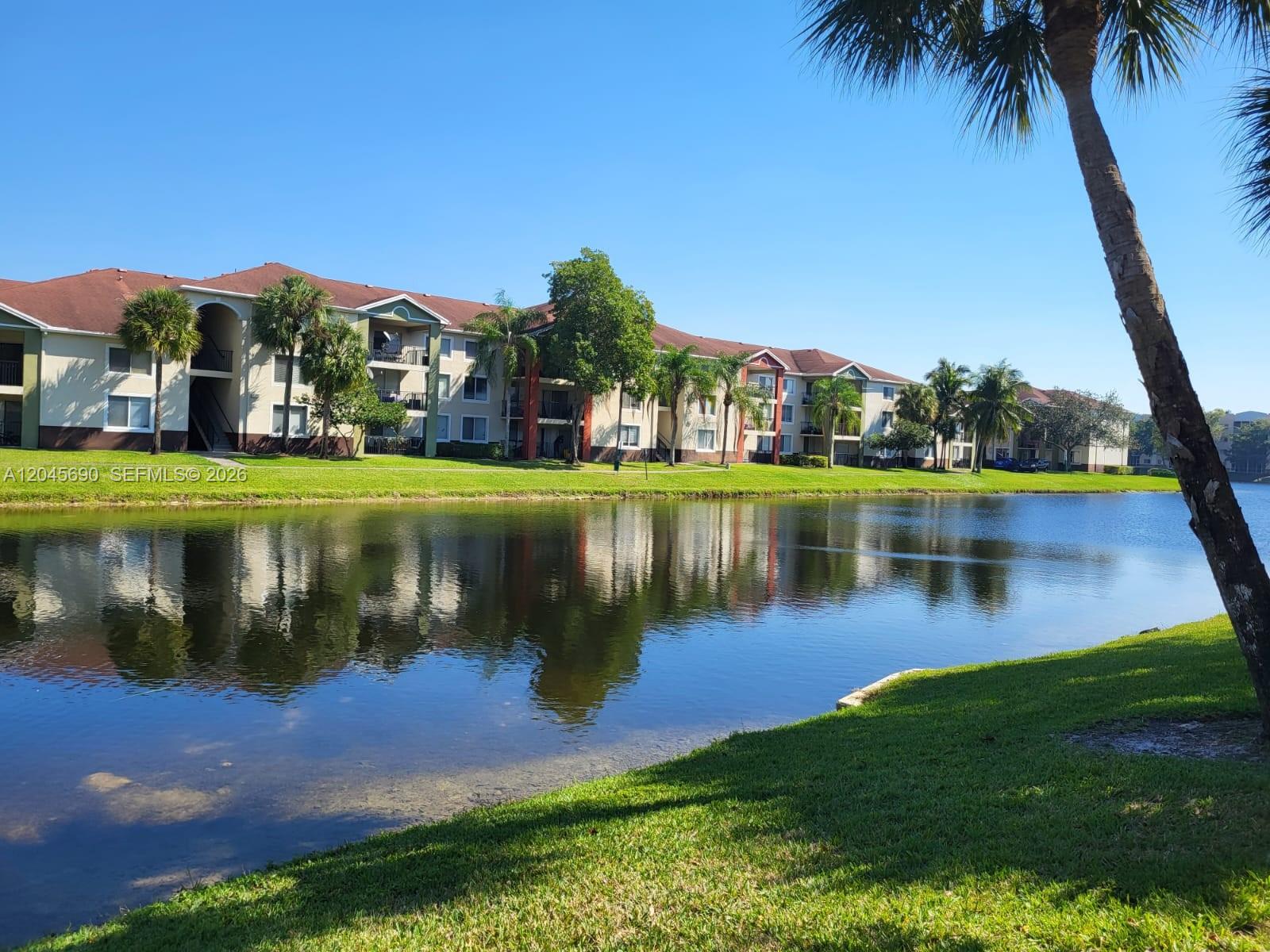 8070 North Nob Hill Road, Unit 208 Tamarac, FL 33321 - Photo 11 of 16 a view of a house with a yard and a patio