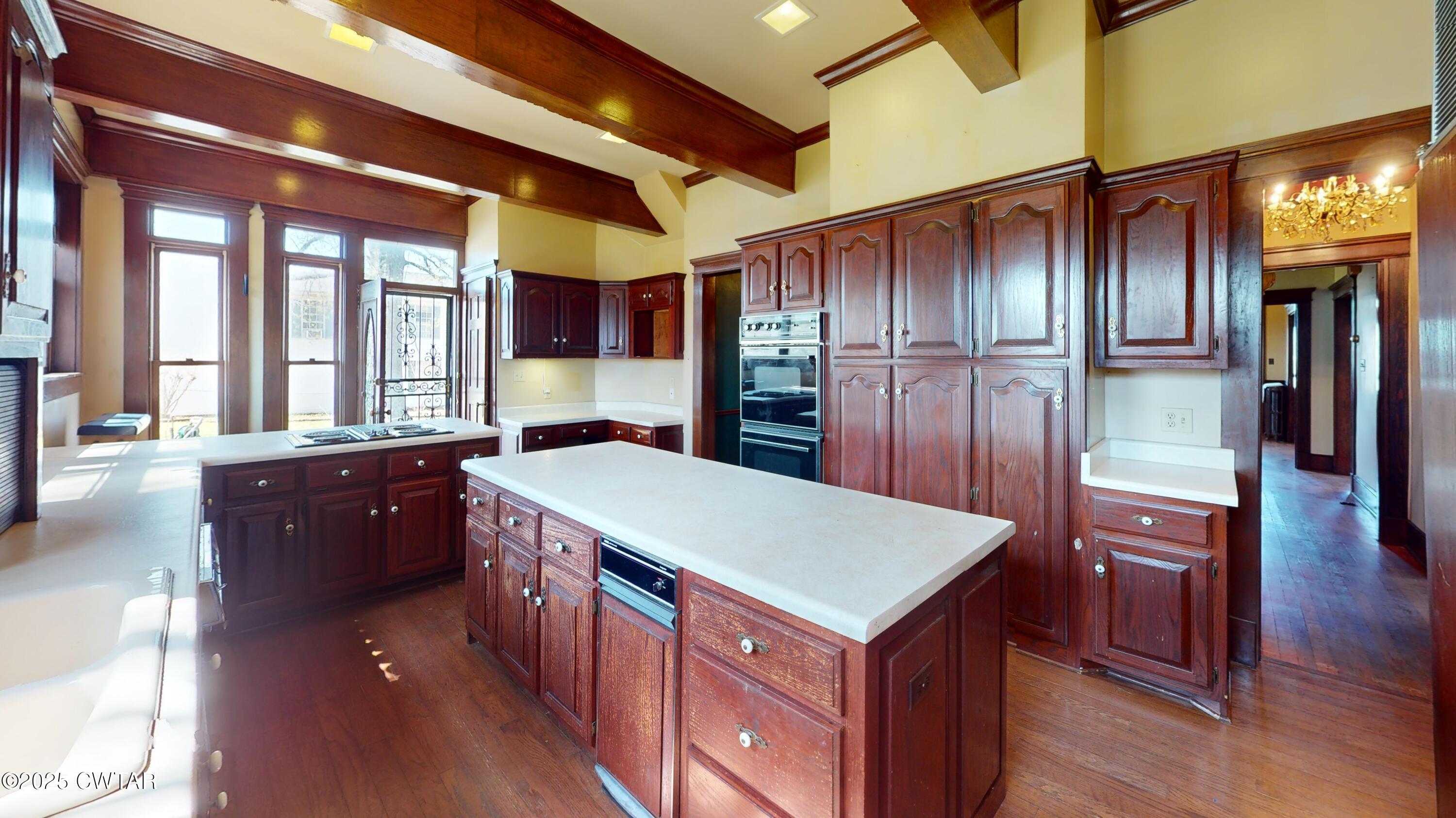 154 South Main Street Ripley, TN 38063 - Photo 13 of 40 a kitchen with a stove a refrigerator and a wooden cabinets