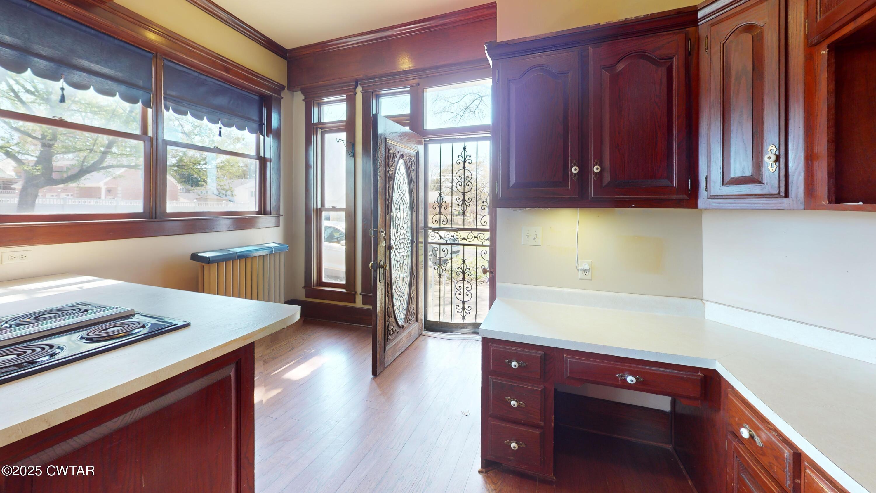 154 South Main Street Ripley, TN 38063 - Photo 14 of 40 a kitchen with stainless steel appliances granite countertop a stove a sink and a refrigerator with wooden floor