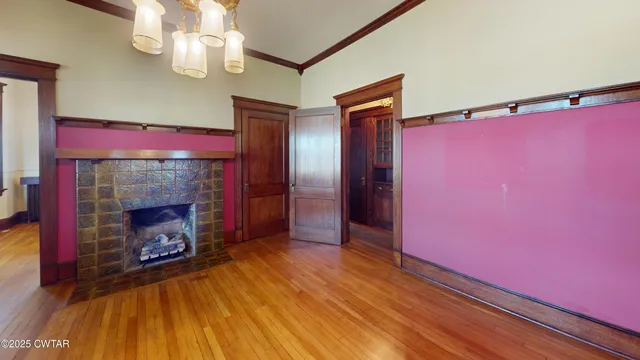a view of a livingroom with a fireplace and chandelier
