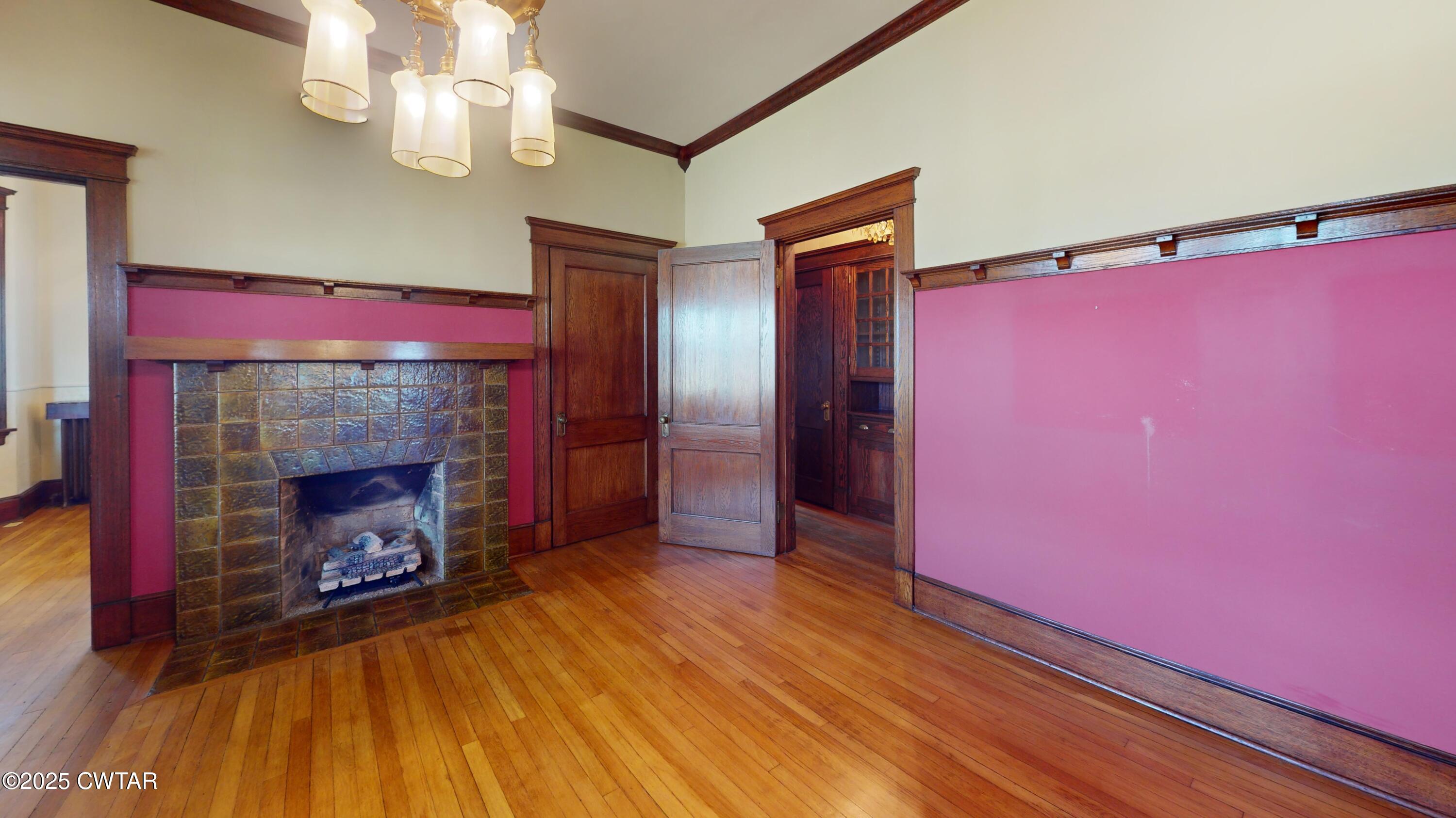 154 South Main Street Ripley, TN 38063 - Photo 7 of 40 a view of a livingroom with a fireplace and chandelier