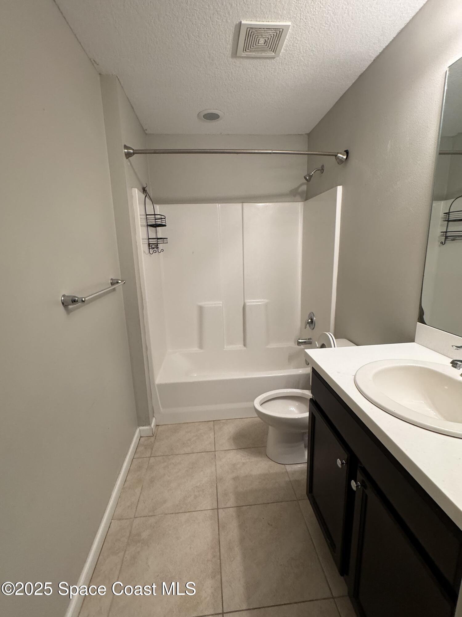 3925 Southwest Laffite Street Port St. Lucie, FL 34953 - Photo 12 of 20 a bathroom with a granite countertop sink a toilet a mirror and shower