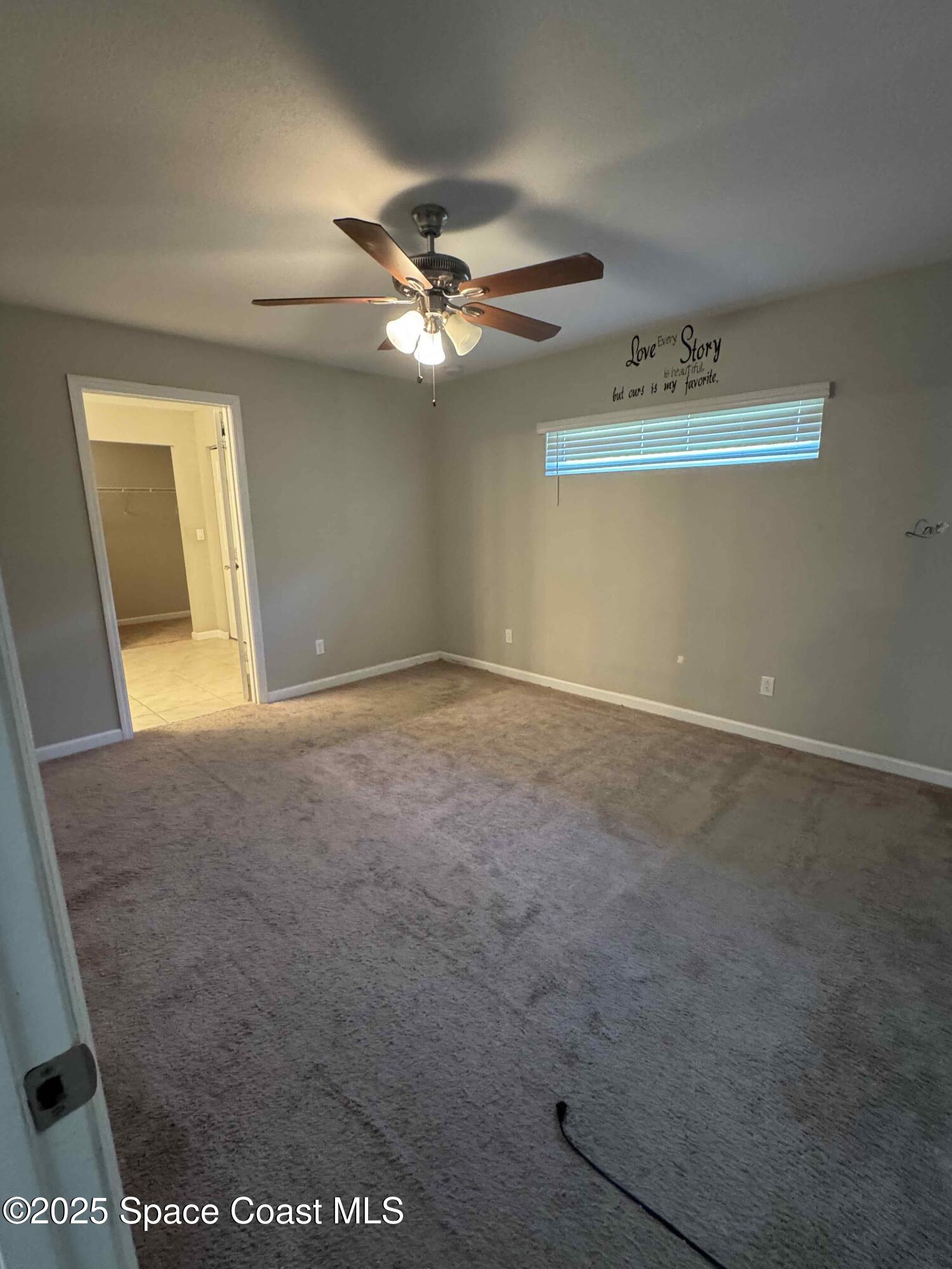 3925 Southwest Laffite Street Port St. Lucie, FL 34953 - Photo 14 of 20 an empty room with windows and fan