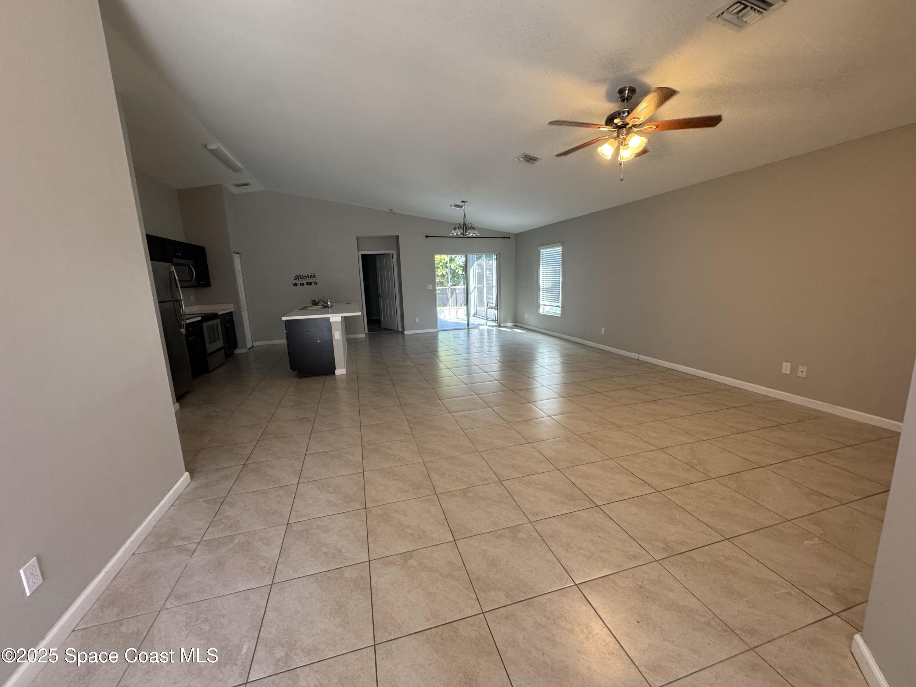 3925 Southwest Laffite Street Port St. Lucie, FL 34953 - Photo 7 of 20 a view of a livingroom with furniture and chandelier fan