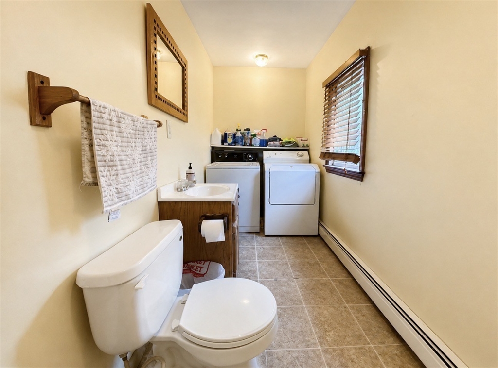 439 Newport Road Hull, MA 02045 - Photo 11 of 19 a bathroom with a toilet sink and mirror