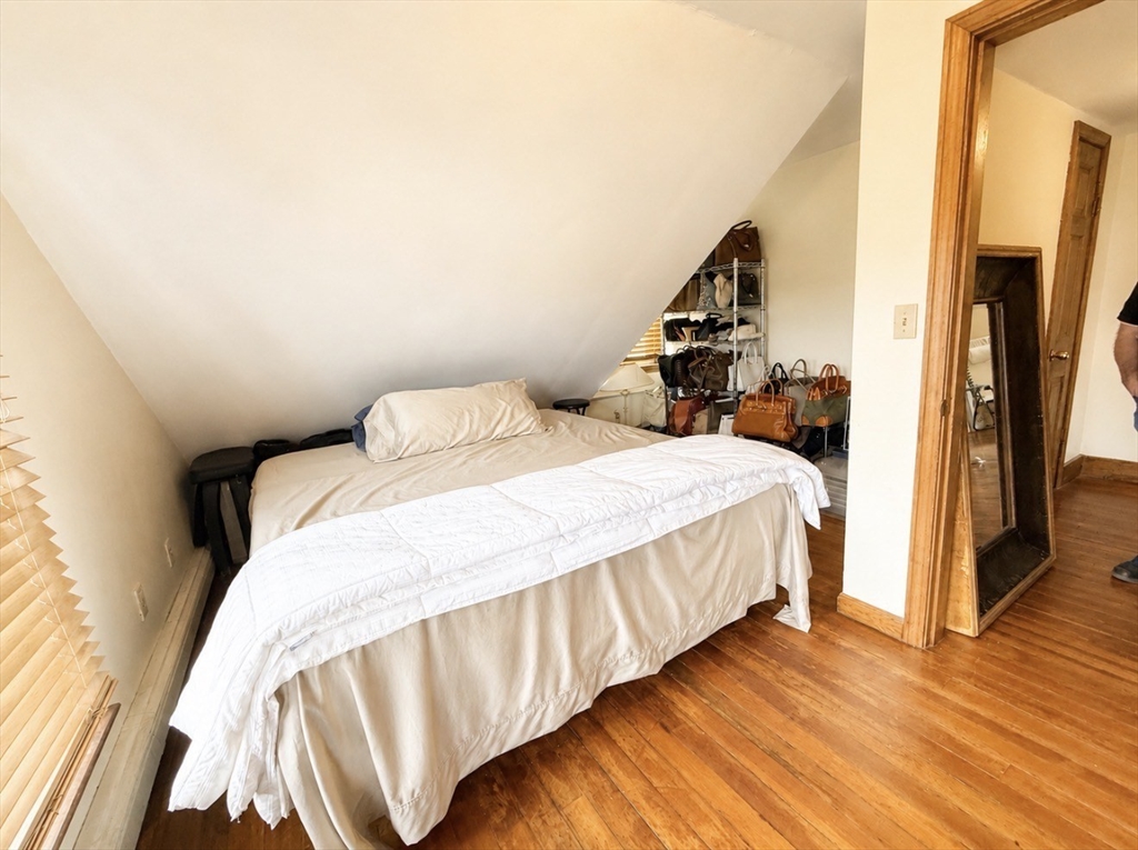 439 Newport Road Hull, MA 02045 - Photo 12 of 19 a bedroom with a bed and wooden floor