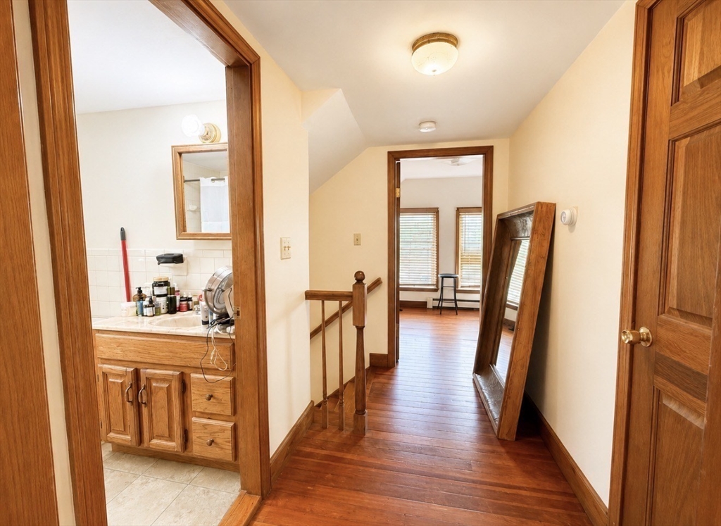 439 Newport Road Hull, MA 02045 - Photo 5 of 19 a view of a hallway with wooden floor and furniture