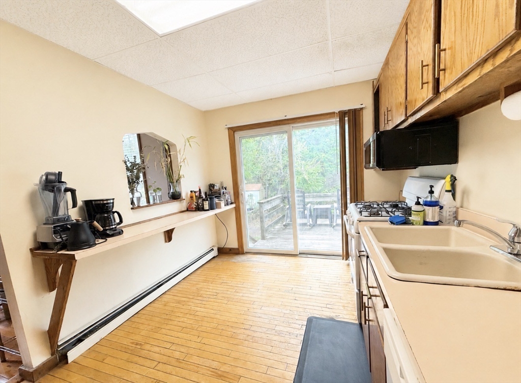 439 Newport Road Hull, MA 02045 - Photo 7 of 19 a large white room with a large window and furniture