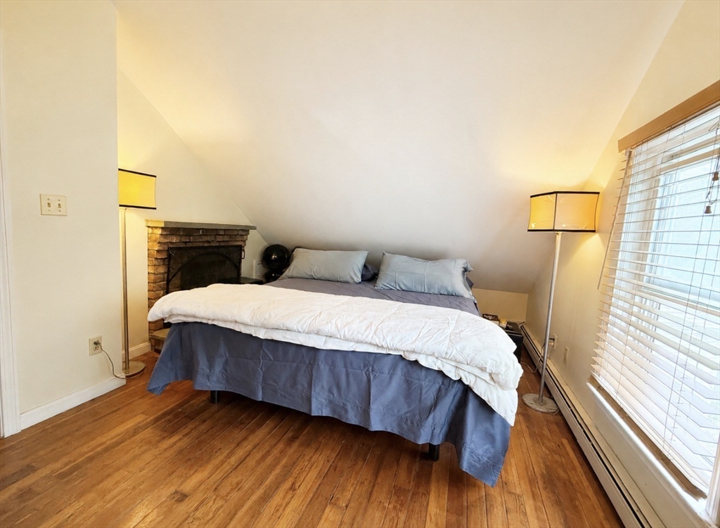 439 Newport Road Hull, MA 02045 - Photo 10 of 19 a bedroom with a bed and wooden floor