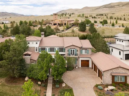 an aerial view of multiple houses with a mountain