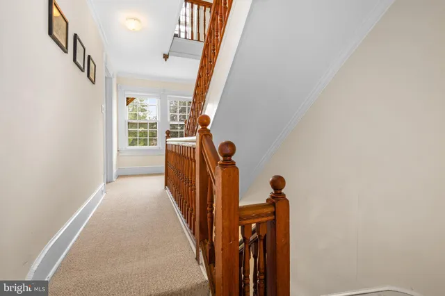a spacious bedroom with a bed and a chandelier