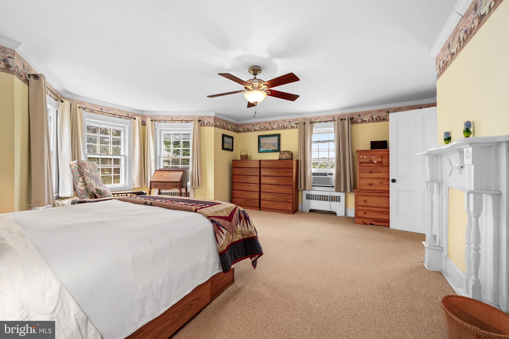 13699 Still Pond Road Still Pond, MD 21667 - Photo 39 of 55 a spacious bedroom with a bed and a chandelier