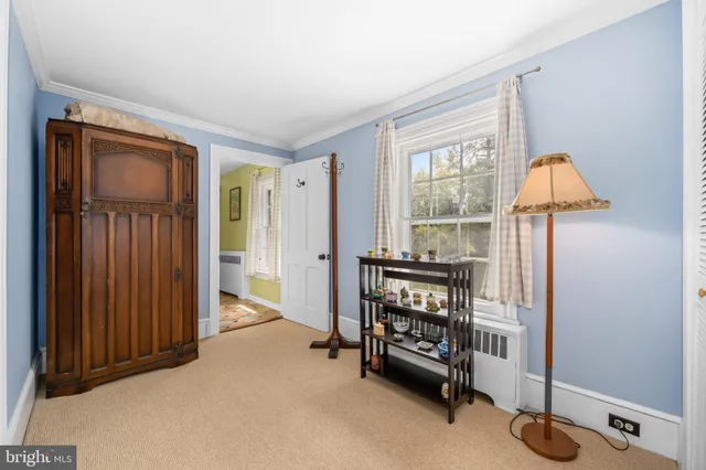 a bedroom with a bed a table and chair