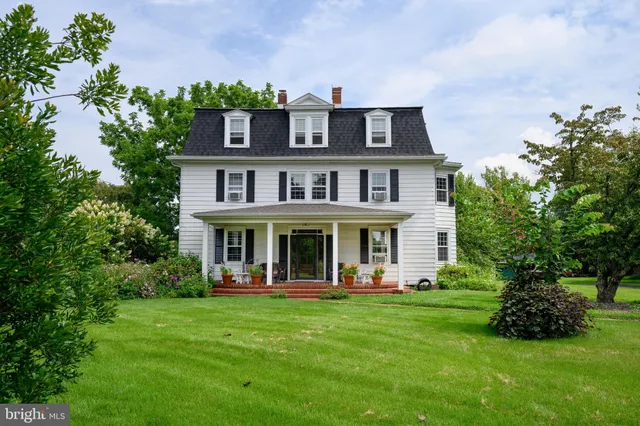 a view of a house with a yard deck and a garden