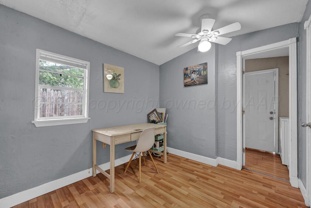 4215 South Tyler Street Amarillo, TX 79110 - Photo 17 of 22 a view of a workspace room with wooden floor windows and chandelier fan