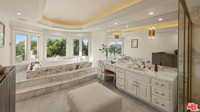 a bathroom with a sink a toilet and a shower