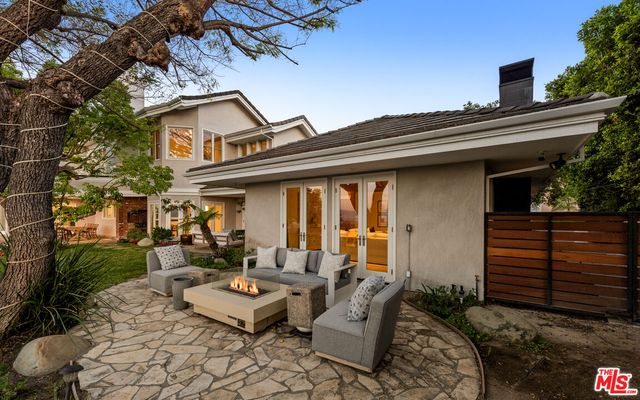 an aerial view of a house with a mountain