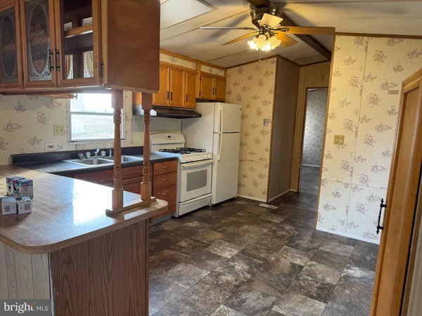 a kitchen with stainless steel appliances granite countertop a sink a stove and a refrigerator
