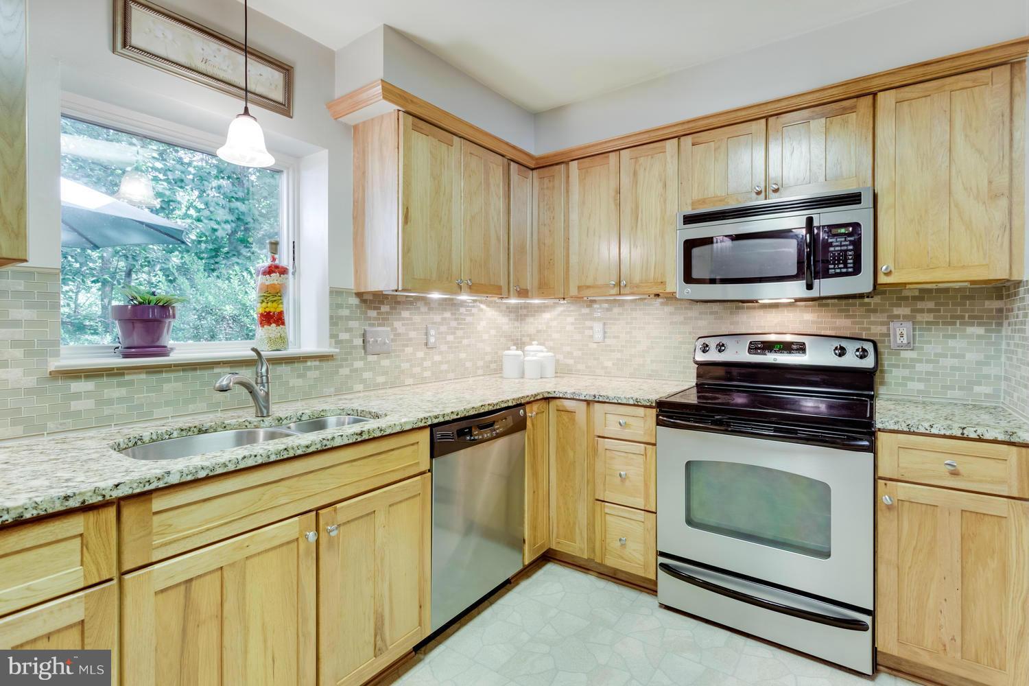 1547 Inlet Court Reston, VA 20190 - Photo 11 of 30 a kitchen with granite countertop a sink cabinets and stainless steel appliances