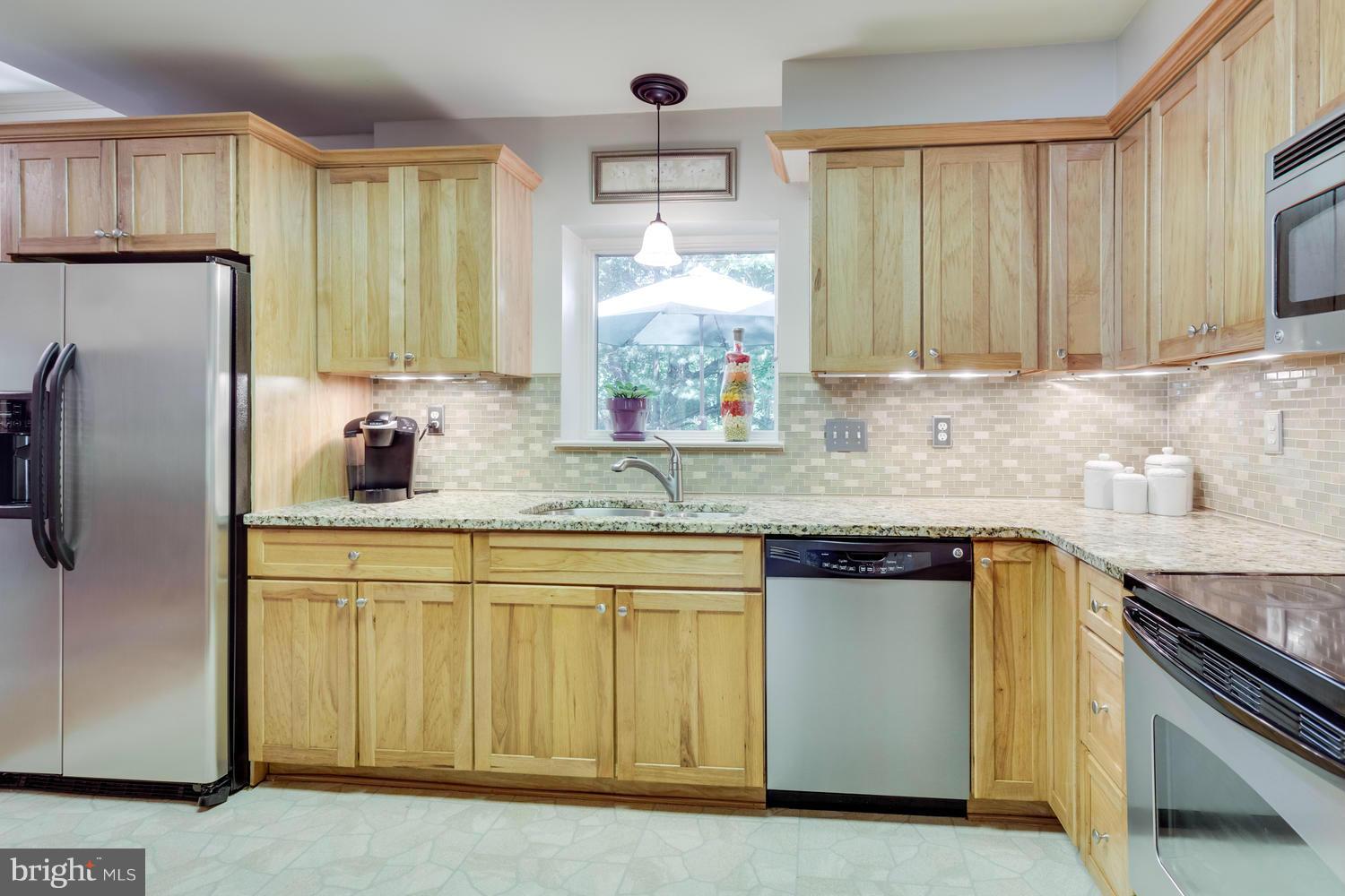1547 Inlet Court Reston, VA 20190 - Photo 12 of 30 a kitchen with stainless steel appliances granite countertop a sink stove and refrigerator