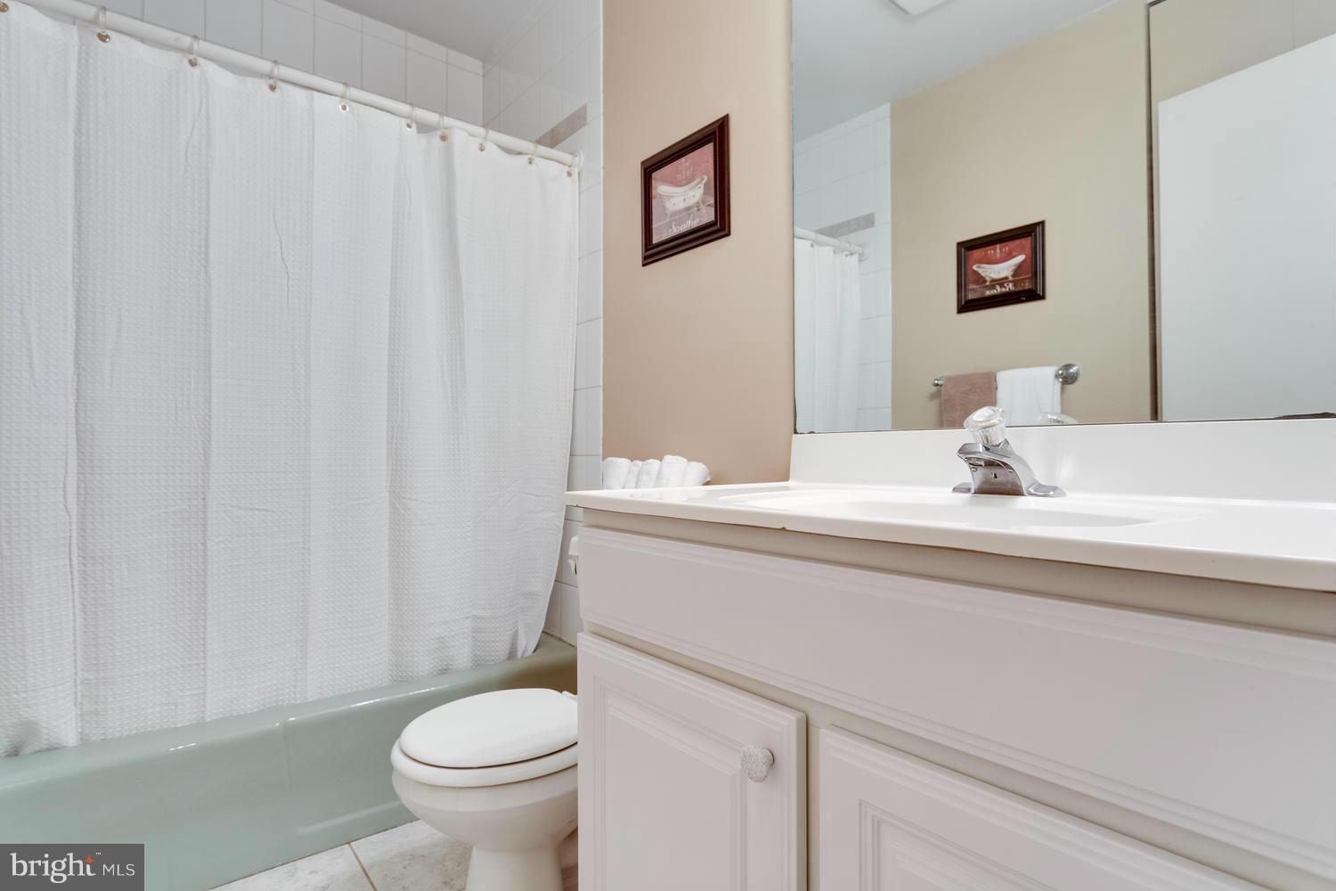 1547 Inlet Court Reston, VA 20190 - Photo 21 of 30 a bathroom with a granite countertop sink toilet and a mirror