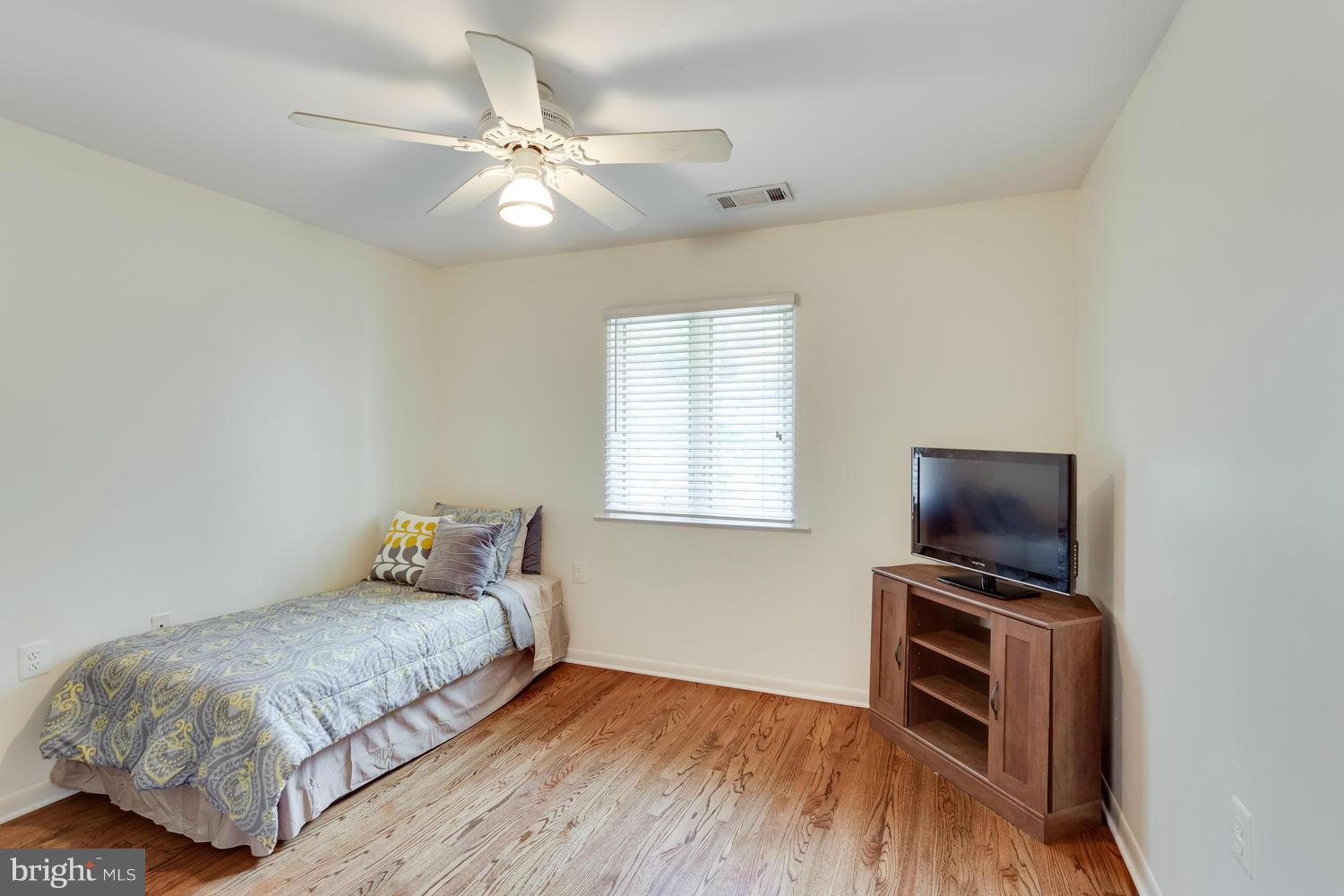 1547 Inlet Court Reston, VA 20190 - Photo 22 of 30 a bedroom with a bed and a flat screen tv