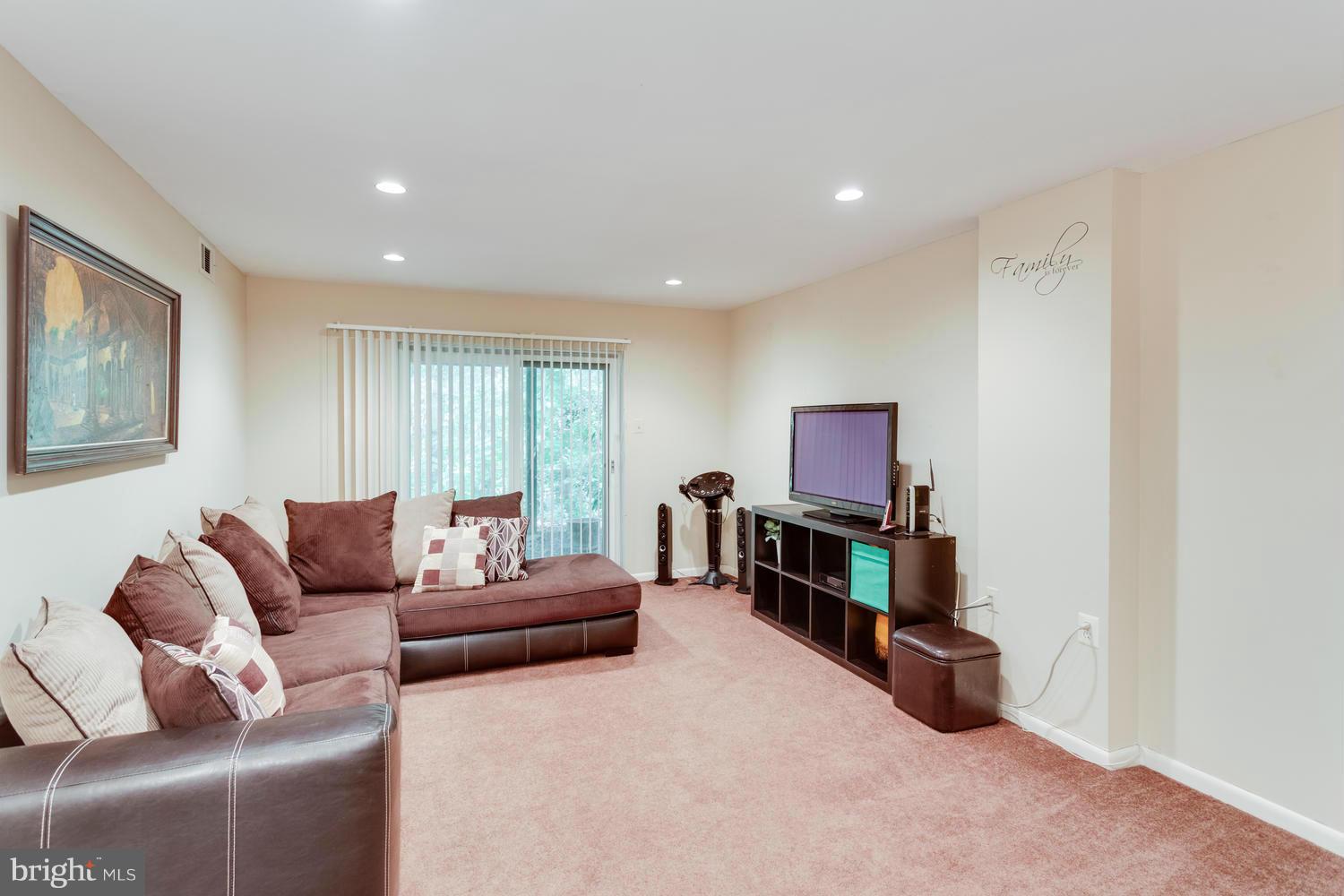 1547 Inlet Court Reston, VA 20190 - Photo 23 of 30 a living room with furniture and a flat screen tv