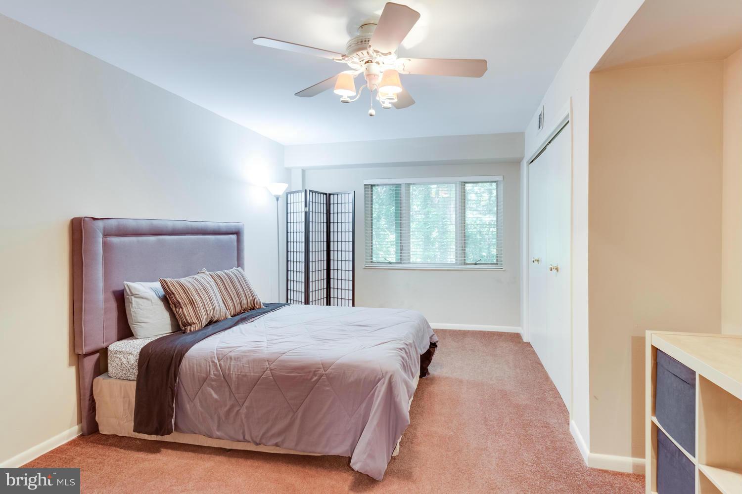 1547 Inlet Court Reston, VA 20190 - Photo 24 of 30 a bedroom with a large bed and a chandelier
