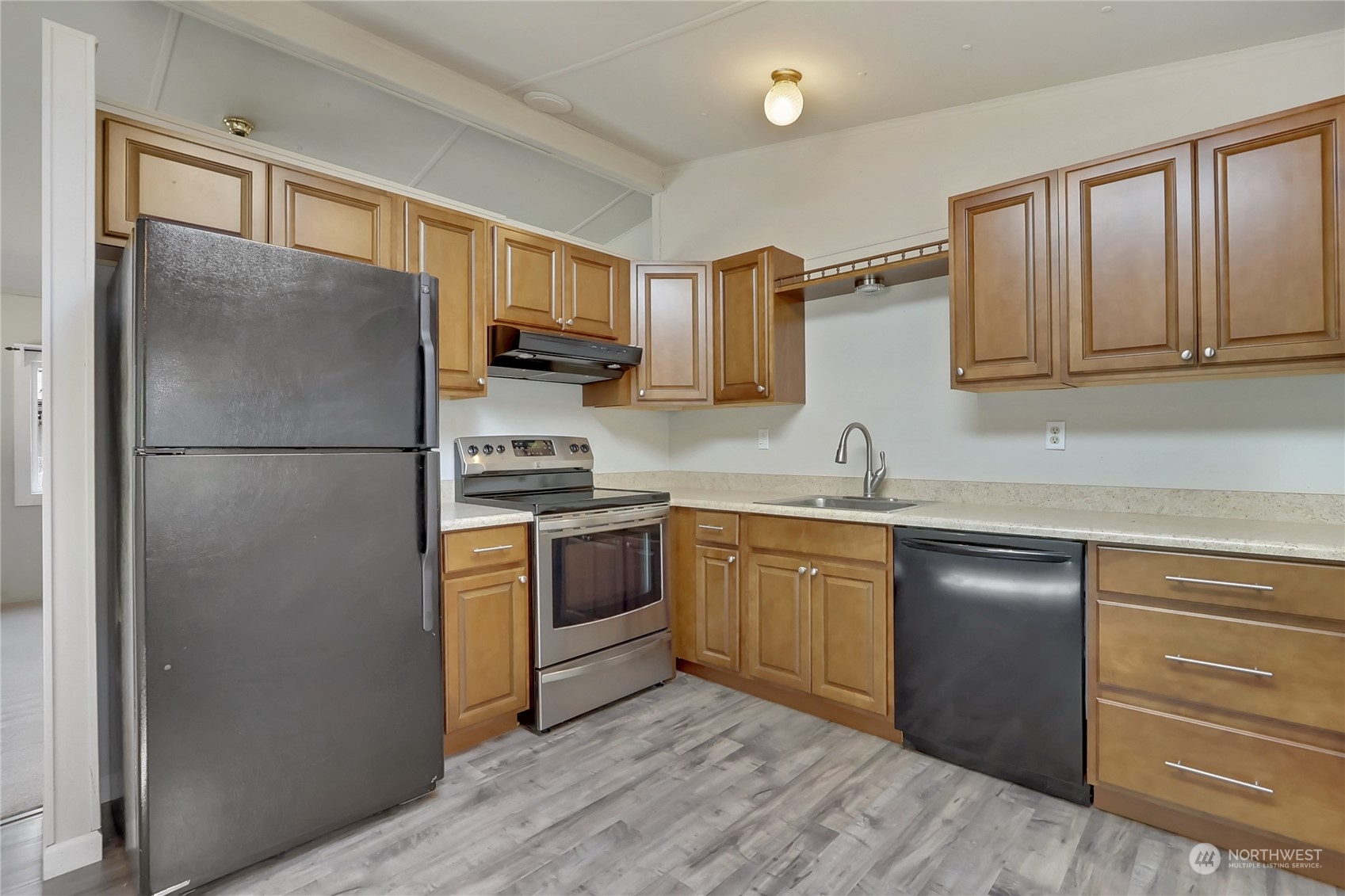 5334 254th Street East Graham, WA 98338 - Photo 9 of 33 a kitchen with a refrigerator stove and sink