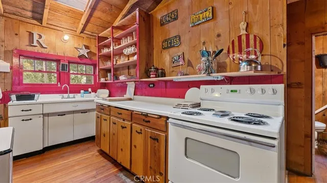 a kitchen with stainless steel appliances granite countertop a stove and cabinets