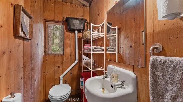a bathroom with a toilet a sink and shower