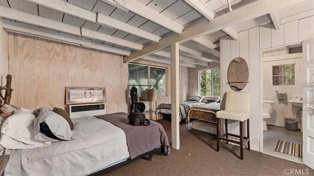 a bedroom with a bed a table and chair