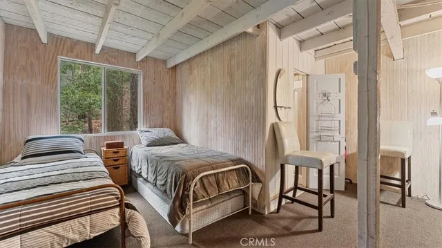 a bedroom with a bed next to a large window with the outer view