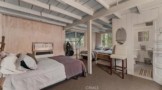 a bedroom with a bed a table and chair