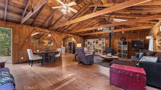 a view of a patio with dining table and chairs with wooden floor