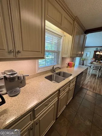 a living room with furniture a flat screen tv and a large window