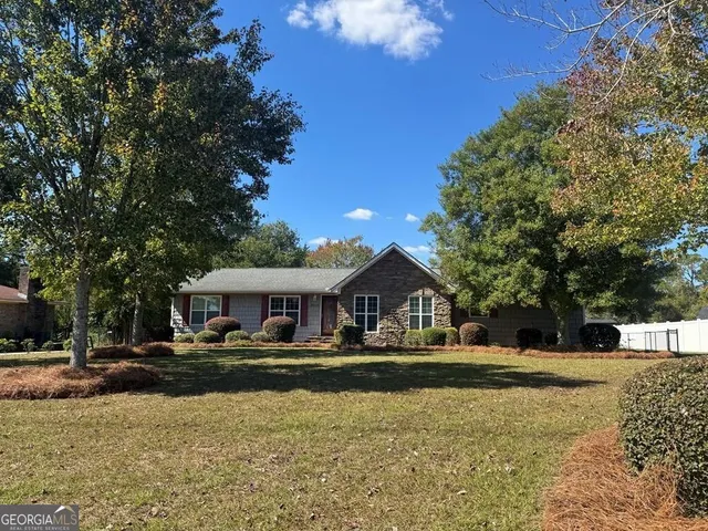 a front view of house with yard and green space