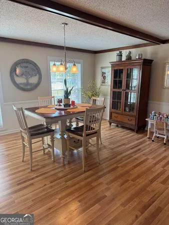 a living room with furniture a flat screen tv and a large window