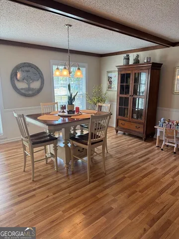 a living room with furniture a flat screen tv and a large window