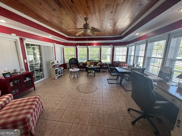 a view of a hallway with wooden floor and windows