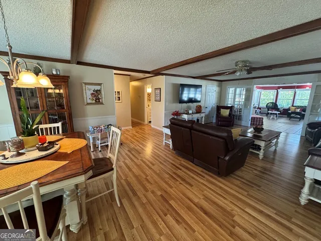 a spacious bedroom with a bed and wooden floor