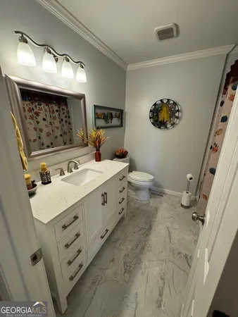 a living room with pool table furniture and a large window