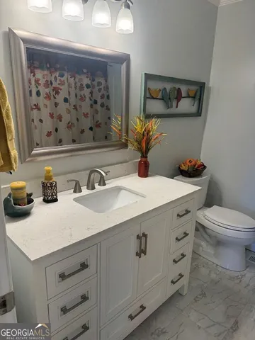 a spacious bedroom with two beds and a flat screen tv