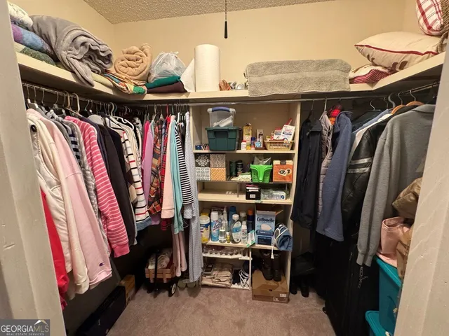 a room with lots of wooden furniture and clutter