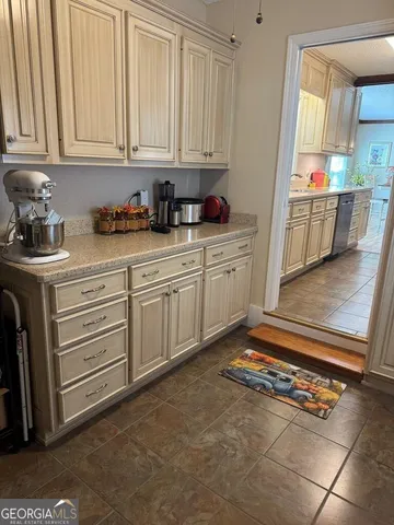 a kitchen with a kitchen island hardwood floor sink stove dining table and chairs