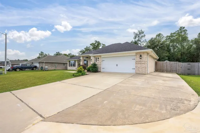 a view of a white house with a yard