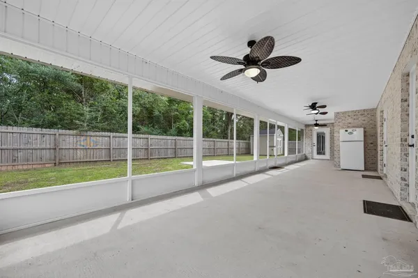 a view of an empty room with floor to ceiling windows
